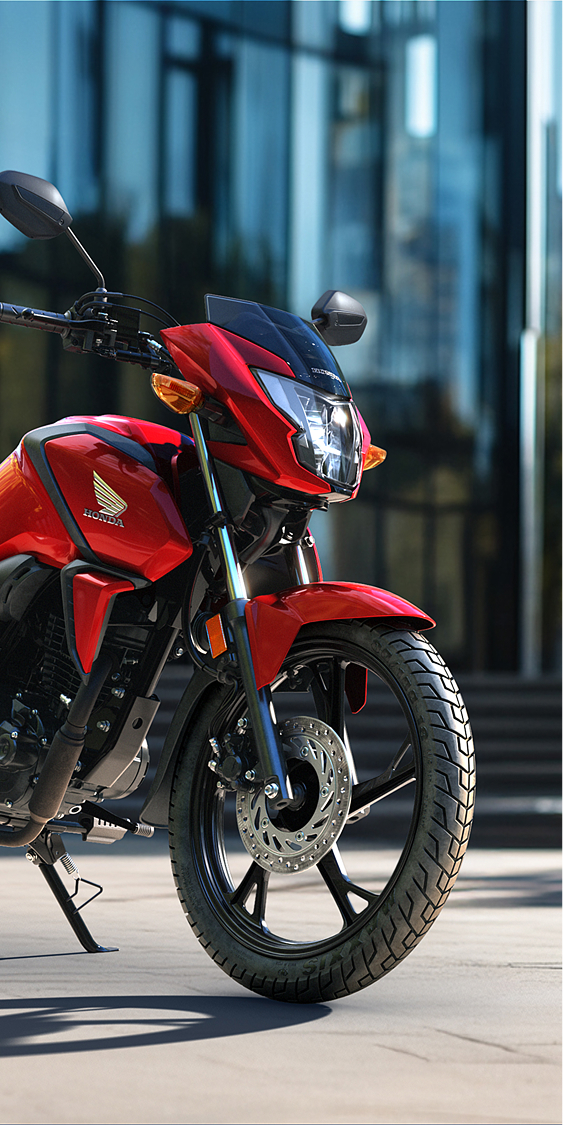 Front three-quarter, left facing CB125F red, on the road, urban location