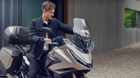 Az NT1100 szélvédője, amelyet egy kézzel állít be a motoros
