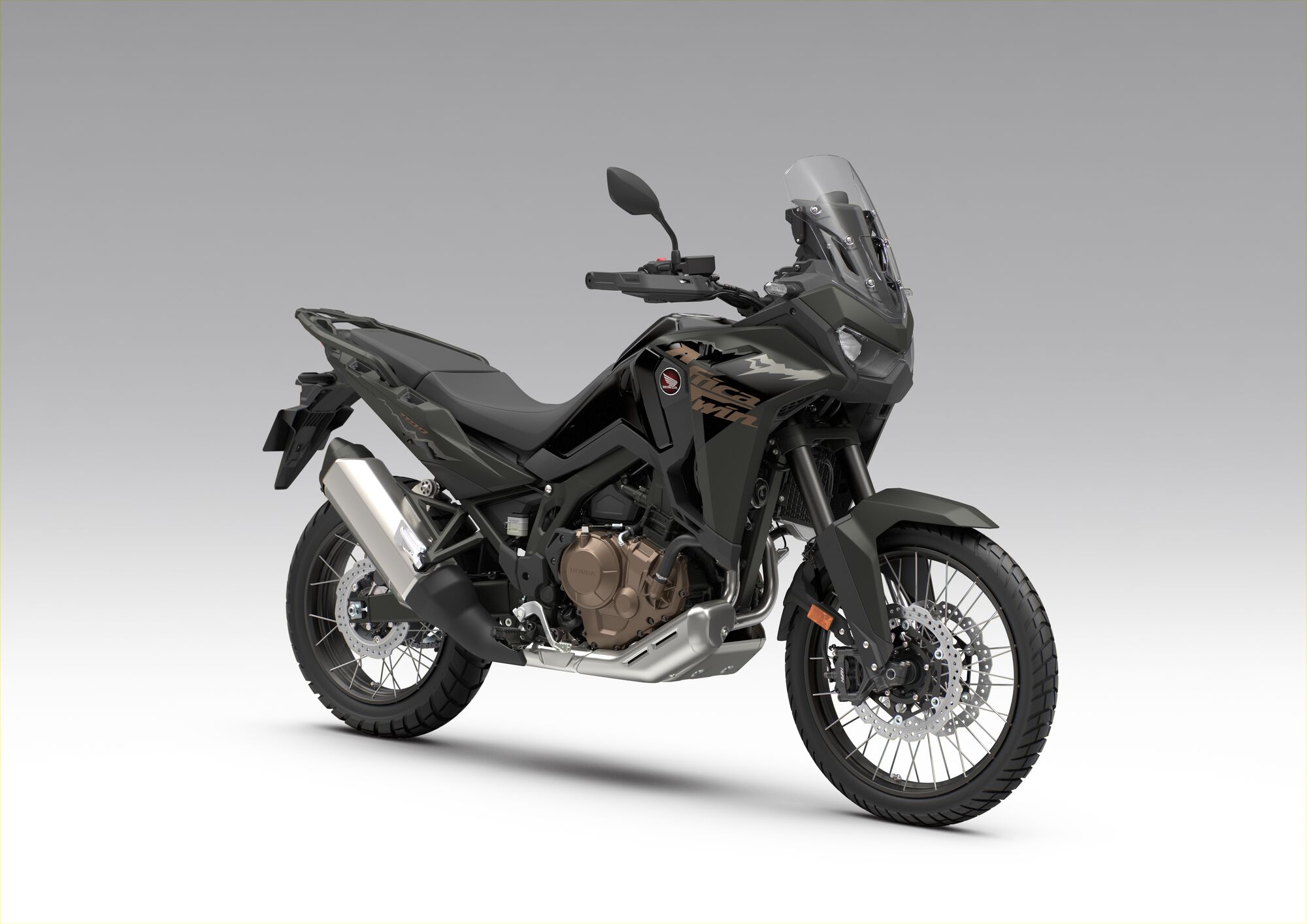A black Honda Africa Twin adventure motorcycle shown in profile view against a plain gray background. The bike features a tall windscreen, rugged tires, and a sleek design typical of dual-sport motorcycles.