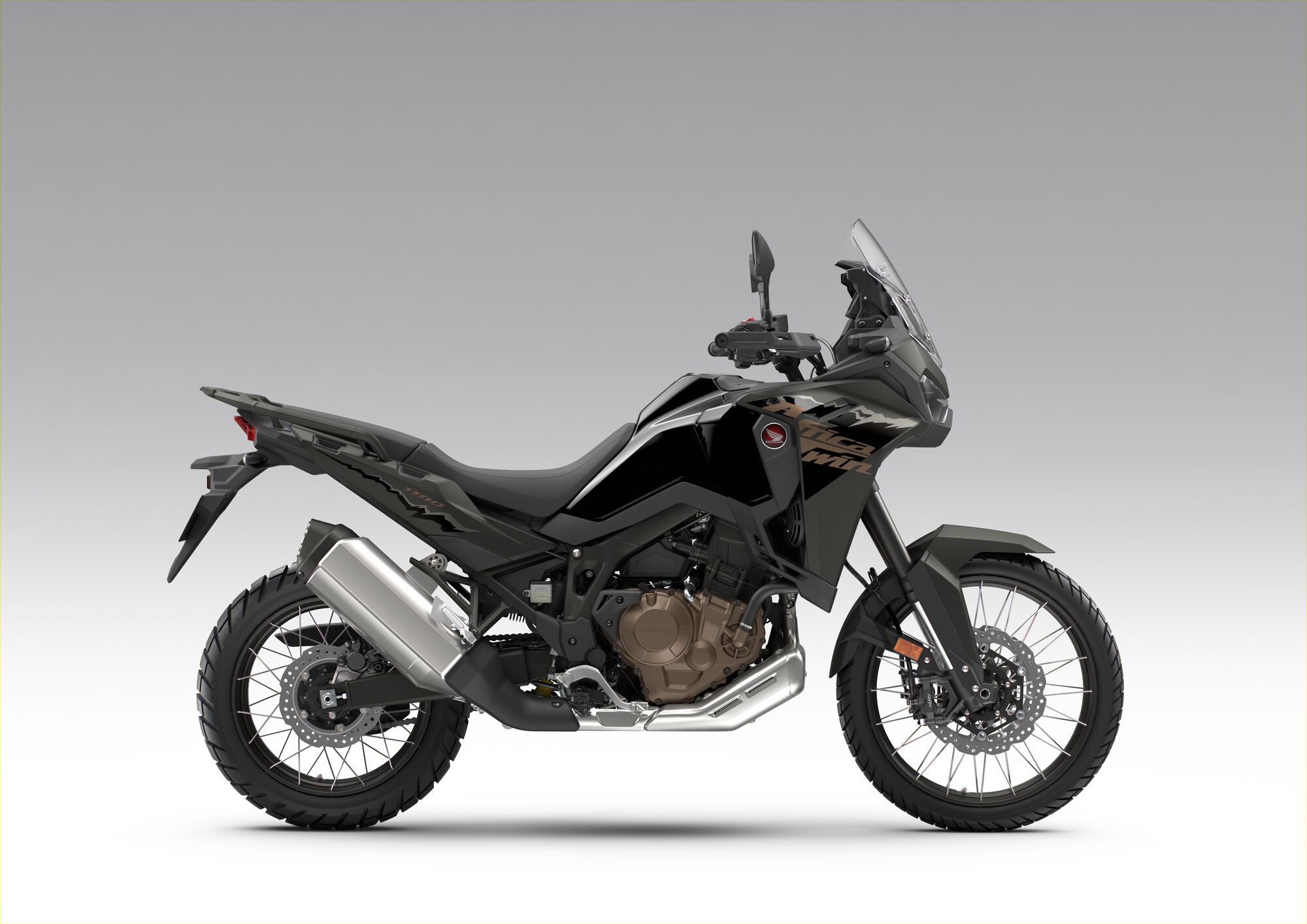 Side view of a black Honda Africa Twin adventure motorcycle against a plain background. The bike features a tall windscreen, rugged tires, and an upright riding position typical of adventure touring motorcycles.